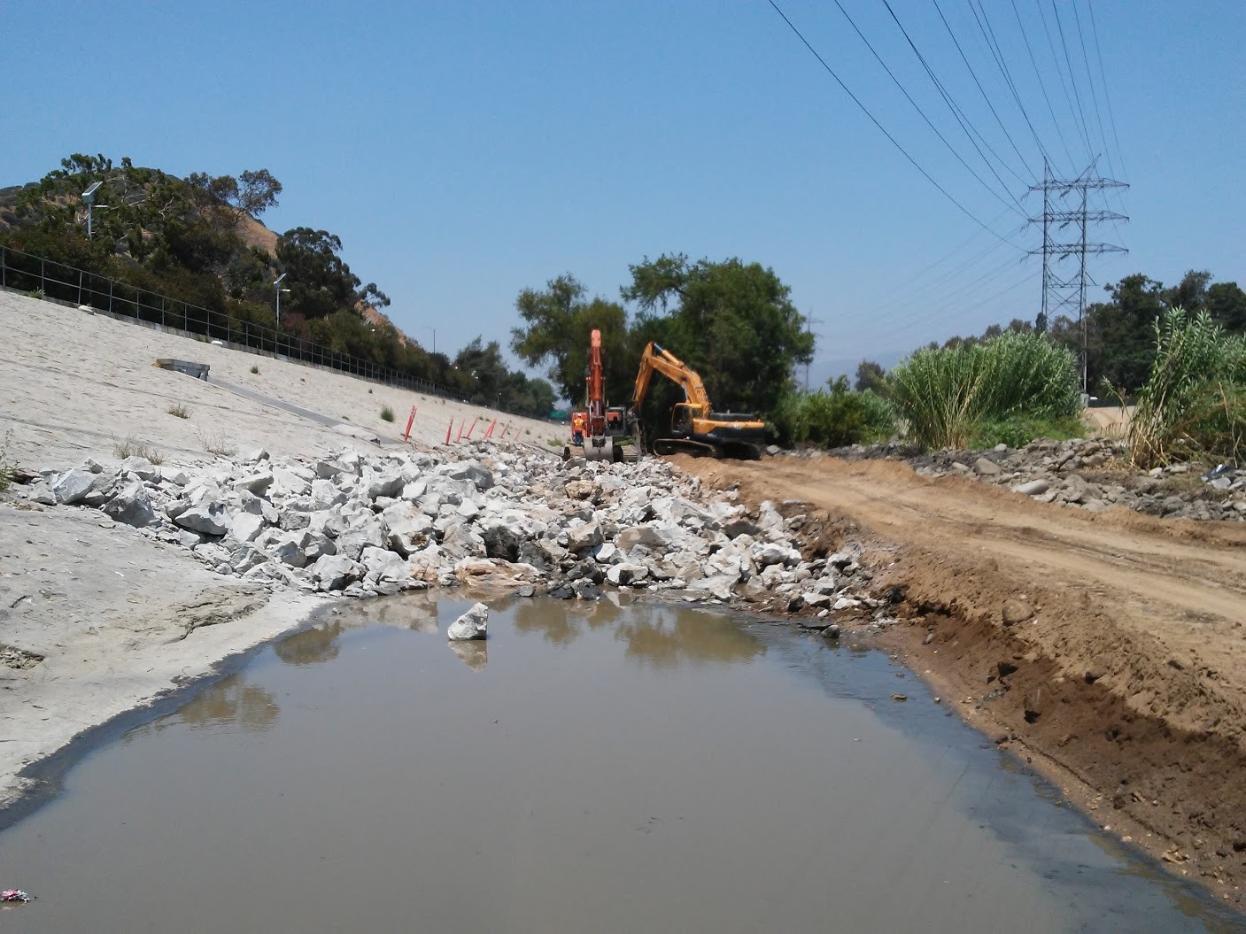 demolition of west levee with excavator