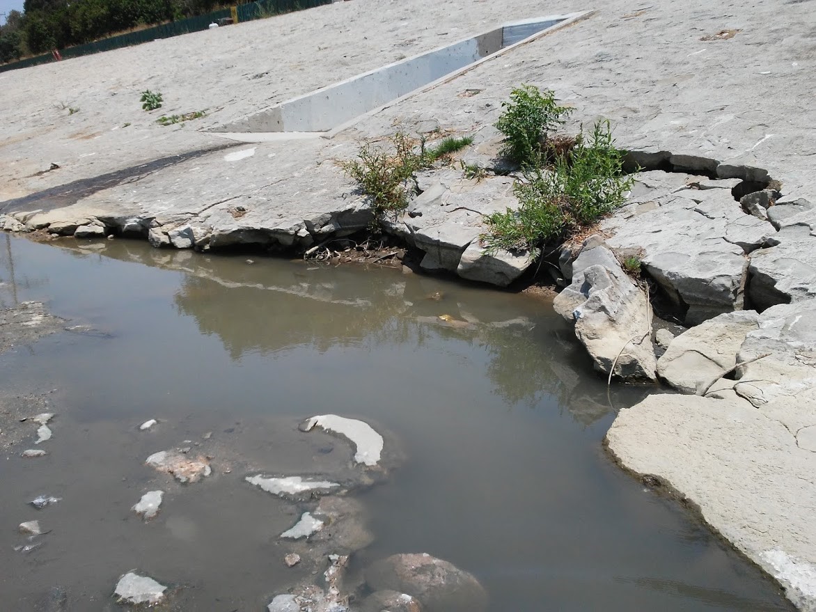 damaged levee exposed as water drawn down