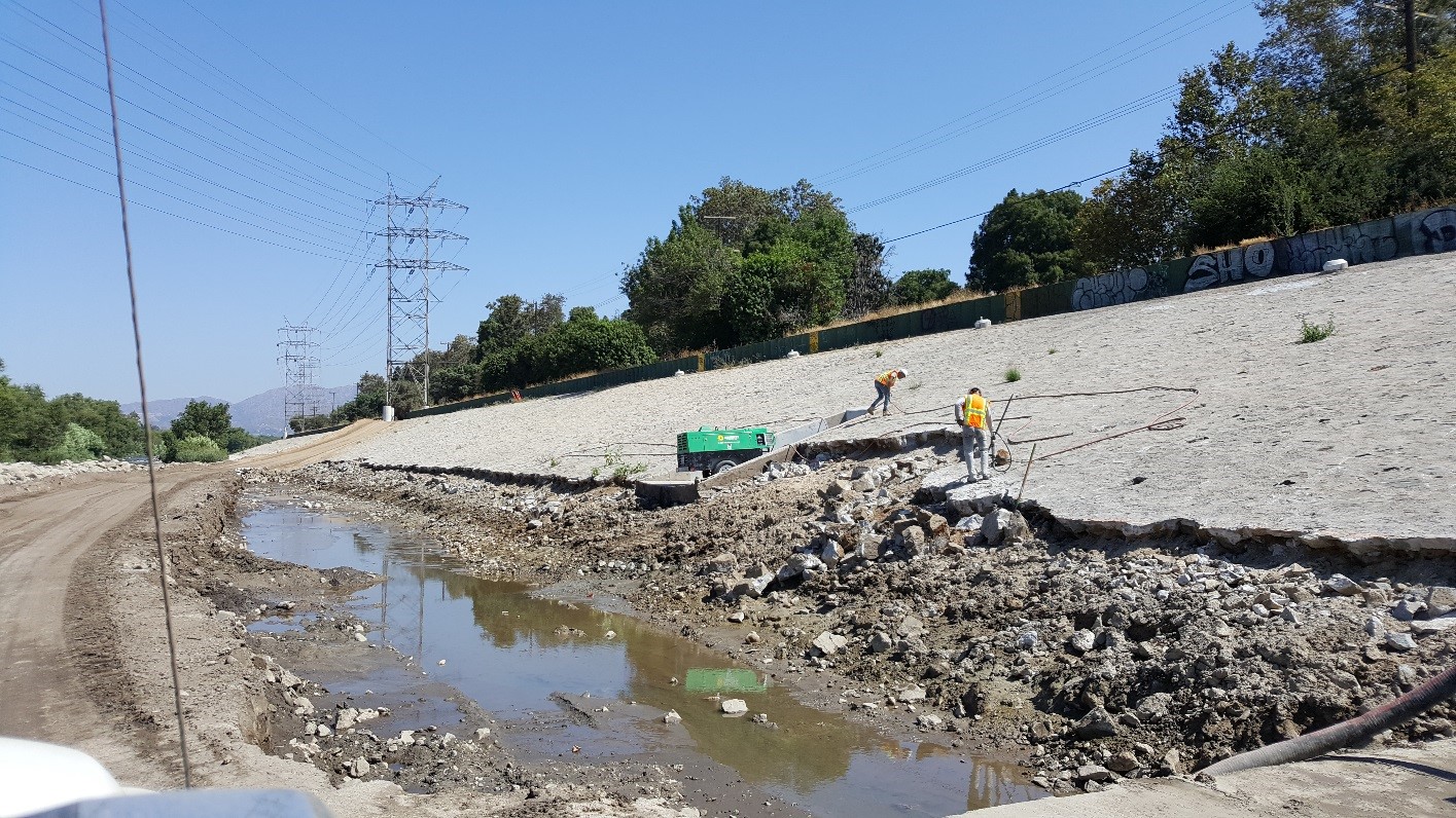 Removing damages sections of grouted stone from left bank